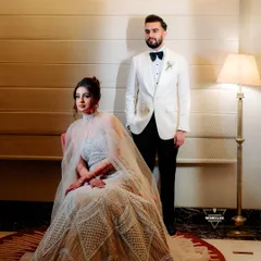A formal, editorial-style portrait. Her seated pose in the stunning gown, complemented by his confident stance, creates a balanced and powerful image. This showcases my ability to direct more formal, posed shots that still feel authentic.