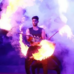 Can you handle the heat? Our performer ignites the stage with a passionate and daring fire act, skillfully dancing with flames to create an intense and unforgettable show.