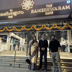 This is the result of a clear vision and relentless execution. Standing with my husband and partner outside our bustling Rameshwaram Cafe, a testament to our success in the competitive F&B industry. I help my clients build brands that people line up for.