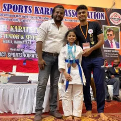 One of our dedicated young students with her well-earned bronze medals from the state championship, a testament to her hard work and fighting spirit.