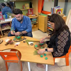 Parents at our orientation session engage in a playdough exploration with natural materials. These hands-on experiences help them understand how we use open-ended play to nurture creativity and fine motor skills in their children.