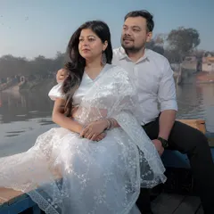 A serene moment captured on a boat at Yamuna Ghat. This pre-wedding shot focuses on the quiet connection between the couple.