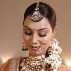 A beautiful bridal portrait showcasing a classic look with a floral bun and traditional jewelry. I used soft, glowing makeup to enhance her natural features for her wedding day.