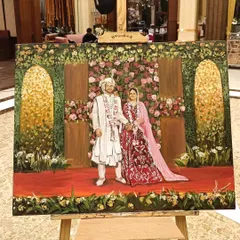 The finished painting from a Delhi wedding, displayed on its easel. This view shows the artwork in its full context, ready for the couple.