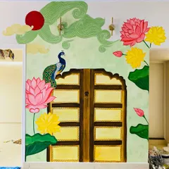 This traditional backdrop for a pooja mantap is one of our favorite projects. We worked closely with the client to bring together elements like the Jaipur-style door, vibrant Pichwai lotuses, and a proud peacock, creating a truly divine space.