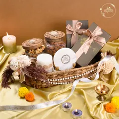 For Diwali, I love creating hampers that glow with warmth and tradition. This wicker basket arrangement combines artisanal candles, jars of premium nuts, and beautifully packaged sweets, all tied together with my custom ribbon to light up your festive celebrations.