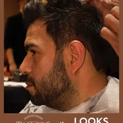 This client is receiving a signature cut and beard shaping. Notice the clean lines and even texture, a result of using professional tools and techniques to create a cohesive, well-groomed look.