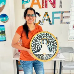A smiling participant with her beautiful Buddha-themed texture art piece.
