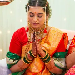 This bride is wearing the traditional 'mundavalya' across her forehead. Her makeup features subtle blush tones and defined eyes, perfectly suited for the solemnity and joy of the wedding rituals.