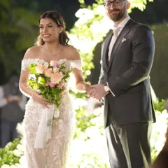 A beautiful moment from the ceremony. Her natural, glowing makeup looks perfect as she shares a smile, proving that the best bridal look is one that lets your happiness shine through.