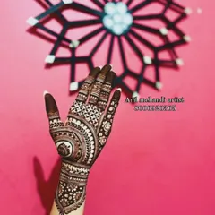 A single hand showing a detailed 'chand' design. The fingertips are fully covered, which gives a very rich and dark final stain.