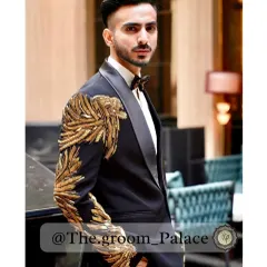 For the groom who dares to be different. This fusion tuxedo in black features stunning gold zardosi embroidery in a wing-like pattern on the shoulders and sleeves, blending classic tailoring with bold Indian craftsmanship.