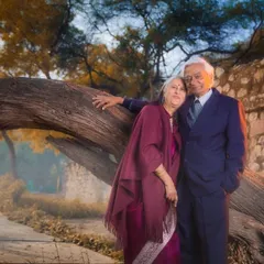 A portrait of the couple celebrating 50 years of togetherness. Leaning against a wise old tree, their pose speaks of a partnership that has been a source of strength and support for five decades.