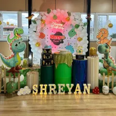 A roaring good time with this dinosaur-themed 6th birthday. The setup is filled with cute dinosaur cutouts, a balloon arch in earthy green tones, and a backdrop that makes you feel like you've stepped into a prehistoric world.