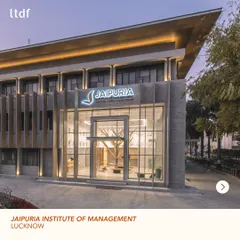 The entrance to the Jaipuria Institute of Management, showcasing the revitalized facade. The design combines modern glass and steel elements with a warm, textured brick, creating an identity that is both contemporary and grounded.