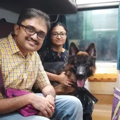 Abhra the German Shepherd poses with his family in their train coupe, ready for a new chapter in Bengaluru after moving from Kolkata. Train travel is a great option for domestic moves.