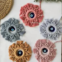 A closer look at the evil eye hangings in five different earthy and pastel colors. Each one is handmade to bring good vibes and protection.