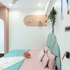 Details like the hanging medals and the small house-shaped shelves make this room truly personal. We believe in creating spaces that reflect the child's achievements and hobbies.