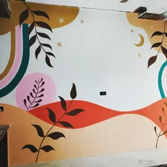 A full view of the abstract botanical mural in progress. This piece combines geometric rainbows with organic leaf shapes, moons, and stars for a whimsical and contemporary feel.