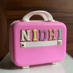 This adorable mini suitcase for a little one was personalized with her name, Nidhi, in colorful, fuzzy letters.