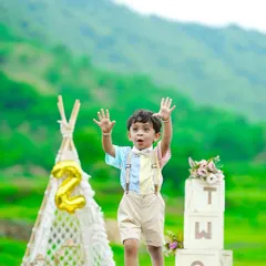 Capturing the pure energy of a two-year-old. This outdoor session uses the beautiful green landscape as a natural backdrop, complemented by our boho-style props like a macrame teepee and "TWO" blocks to celebrate his second birthday milestone.