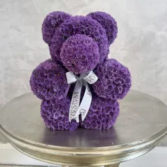 This cuddly purple bear wants to give you a big hug. Made from fresh purple chrysanthemums and finished with our custom ribbon, it's a delightful and unique floral gift for baby announcements or Valentine's Day.