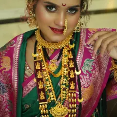A close-up capturing the regal essence of a Peshwai bride. The focus is on the rich gold jewellery, the intricate nath, and the deep, expressive eyes, creating a look that is both powerful and graceful.