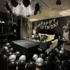 For a sleek and modern celebration, I used a black, silver, and white palette. The balloons are arranged around the chandelier and across the room, with fairy lights on the bed adding a warm, intimate glow.