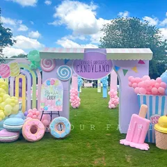 Welcome to the sweetest party in town. We designed this sprawling outdoor Candyland theme with a grand entrance, giant pastel lollipops, donuts, and ice cream props, creating a whimsical wonderland for guests to explore.