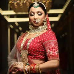 The final touches on a beautiful bride. This image showcases the intricate details of the jewellery and the flawless makeup application that brings the entire look together.