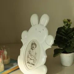 Add a touch of magic to your little one’s world with this adorable white bunny photo frame. Its playful design and soft hue make it a lovely addition to any nursery or playroom.
