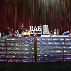 For grand celebrations, we deliver a bar to match. This setup features a fully stocked, LED-illuminated bar, ready to serve hundreds of guests with speed and style, making it a stunning centerpiece for any large wedding or corporate event.