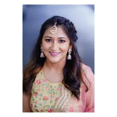 A classic bridal portrait, focusing on the bride's joyful expression and the intricate details of her makeup and embroidered lehenga. I aim for portraits that feel natural and radiant, not stiff.