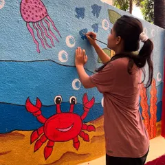 Here I am painting the final touches on the underwater scene, adding bubbles and small fish to bring the ocean world to life.