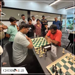 Players and spectators gather around a board to watch a critical game unfold during our Independence Day tournament. The shared passion for chess creates a strong sense of community.