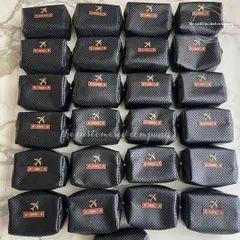 For a sleek and masculine look, these travel pouches feature a black carbon-fiber texture. Each pouch is personalized with a name on a leather tag, making it a sophisticated travel accessory for him.