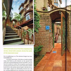 This spread from GoodHomes magazine showcases the home's entrance, built with locally sourced Delhi quartzite stone. It details how using natural materials provides better thermal capacity and requires less long-term maintenance.