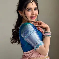 The joy on my client's face says it all. For this South Indian traditional look, I used soft pinks on the eyes and lips to complement her silk saree, ensuring her skin looked fresh, dewy, and luminous.