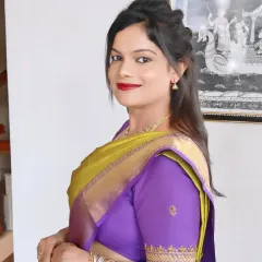 A smiling portrait of Kalyani. Her makeup is traditional yet fresh, perfect for any South Indian family gathering.