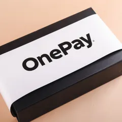 The exterior of the OnePay welcome kit, featuring a clean and bold branded sleeve. Professional packaging is key to making a great first impression on new team members.