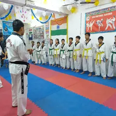 I am addressing the students before their belt test, explaining the requirements and offering words of encouragement.