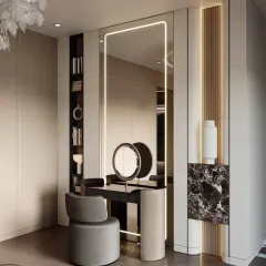 This bedroom design includes a glamorous vanity and dressing area. The full-length mirror with integrated lighting and sleek black-and-marble dressing table create a perfect spot to get ready.