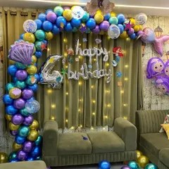 An enchanting mermaid-themed birthday for a 4-year-old. We used a vibrant balloon arch in ocean colors, a "Happy Birthday" foil sign, and mermaid-themed foil balloons to create an underwater fantasy.