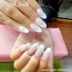 Another example of a flawless classic French manicure on long, almond-shaped nails, showcasing the clean lines and natural-looking base.