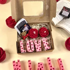 Gifting just got a lot more personal. My 'Spell & Shine' gift box lets you spell out your love with name candles, and includes rose candles, a teddy, and polaroids of your favorite memories.