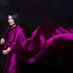 For a touch of desi elegance, a satin saree in the studio creates a stunning and dramatic look. The way the fabric flows highlights your beautiful bump with grace and style.