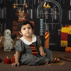 It's not just for Harry. This little girl makes a perfect Hermione Granger, captured in our Hogwarts library set for her first birthday.