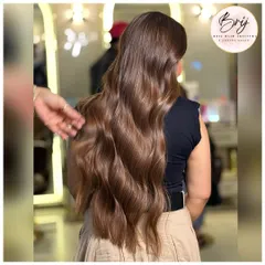 From the back, you can see the seamless flow of this rich brown color. The soft waves and healthy shine make this a truly timeless and elegant look.