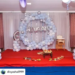 This setup was for Nivaan's Annaprashan, or first rice-eating ceremony. I created a gentle blue and silver theme with a circular balloon arch, a foil name banner, and a number '6' balloon to mark his six-month milestone.
