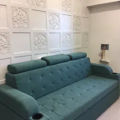 This is a custom-made sofa that also functions as a comfortable bed. It features adjustable headrests and convenient cup holders, making it a perfect multi-functional piece for any living room.